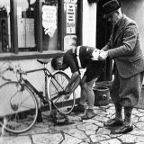 Tommy tweaks bike as Charlie Davey brings a cuppa